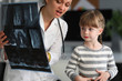 © H_Ko - Child doctor specialist look x-ray image in hospital