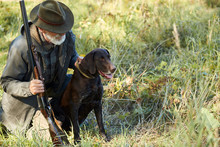 Senior Hunter And His Dog In Forest, Look For Prey, Hunting On Wild Animals. Hunting Season