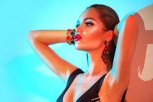 High Fashion Model Woman In Colorful Bright Lights Posing In Swimsuit, Portrait Of Beautiful Sexy Girl In Swimwear, Trendy Accessories And Make-up. Art Design Colorful Make Up. Summer Fashion. Makeup