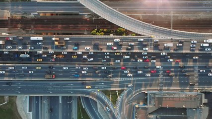 Wall Mural - Beautiful aerial view to the cars driving on multi-level highway in Moscow. Direct view from above to the road traffic in a big city on the sunny evening.