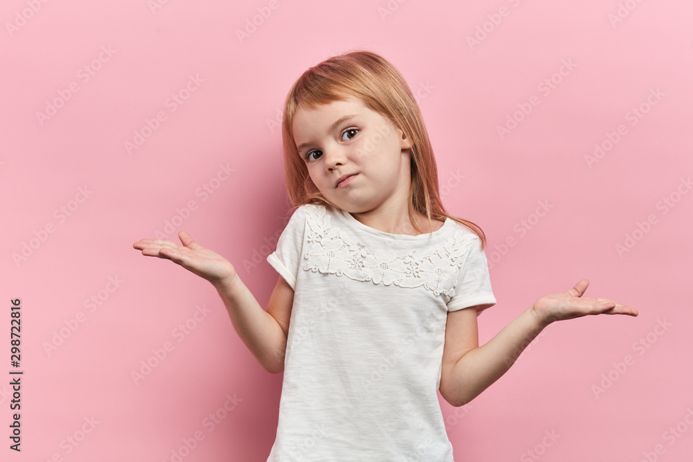 lovely beautiful girl with raised arms shrugging her shoulders, expressing her doubte, girl cannot solve a problem, answer the question, close up portrait, isolated pink background, body language - obrazy, fototapety, plakaty 