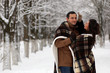 © alexkich - A young couple walk in a winter park
