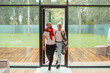 © alfa27 - Attractive family couple entering new house, happy to spend time here. Background big panoramic window