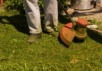 Man mowing the lawn in summer, photography