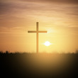 christian cross at sunset sky
