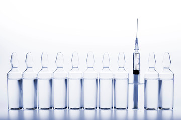 Wall Mural - Glass medicine ampoules and Syringe on white background