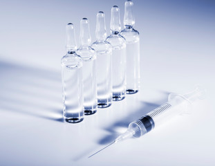 Wall Mural - Glass medicine ampoules and Syringe on white background