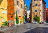 Fototapeta Uliczki - View of old narrow street in Rome, Italy. Architecture and landmark of Rome. Cozy cityscape of Rome.