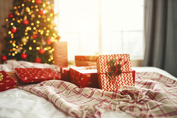 Wall Mural - christmas gifts on bed near christmas tree in morning in bedroom .