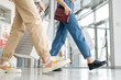 © pressmaster - Young woman and her daughter in jeans carrying paperbags while leaving mall