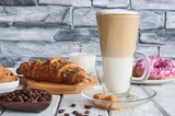 Delicious sweet breakfast. Latte macchiato coffee with various sweets.