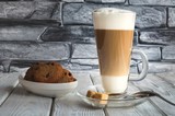 Delicious sweet breakfast. Coffee latte macchiato with cookies on a wooden table.