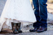 bride and groom with cowboy boots