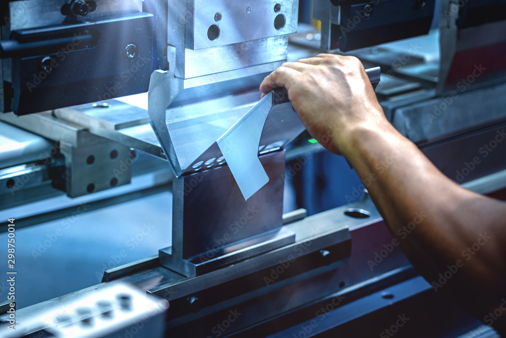 Workers bending sheet metal by CNC machines in industrial plants - obrazy, fototapety, plakaty 