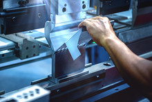 Workers Bending Sheet Metal By CNC Machines In Industrial Plants