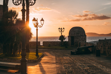 Wall Mural - ALGHERO, ITALY/ OCTOBER 2019:  Wonderful sunset over the ancient fortifications