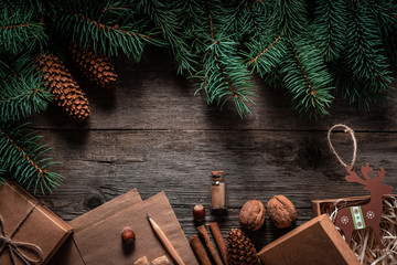 Wall Mural - Christmas green frame from fir branches on a vintage gray board background. Frame of fir branches. Christmas card blank.