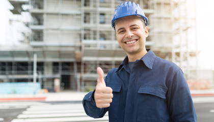 Wall Mural - Site manager giving thumbs up in front of a construction site