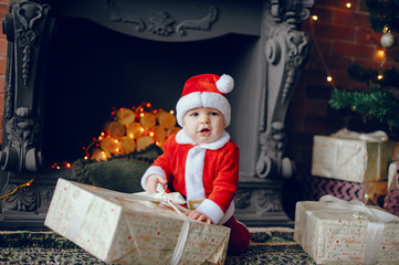 Poster - Cute little boy in a christmas costume. Child by the christmas tree