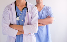 Two Doctor Team In The Hospital For Health Care Concept . Blue Uniform.