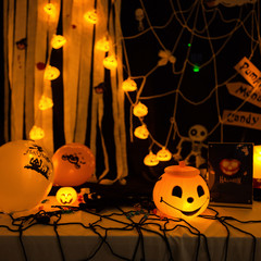 Wall Mural - Scary Halloween pumpkins on dark background. Halloween card concept. Spooky glowing faces with candlelight.