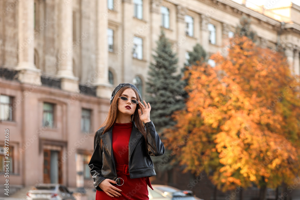 Stylish young woman in autumn city