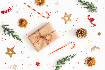 Christmas composition. Gift box, fir tree branches, golden decorations on white background. Christmas, winter, new year concept. Flat lay, top view