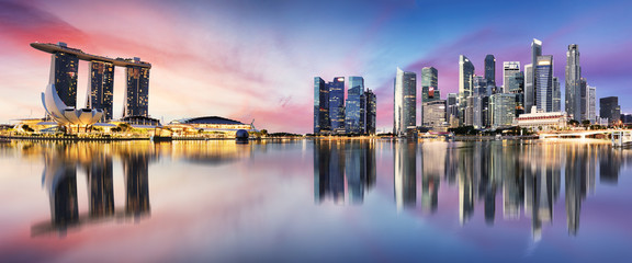 Wall Mural - Singapore skyline at sunrise - panorama with reflection