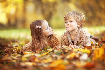 Funny twins in autumn park