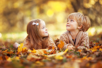 Funny twins in autumn park