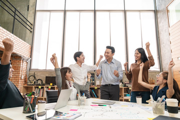 Happy asian creative team or staff employee feeling enjoy and looking together in meeting room at modern office. Brainstorming and planning to achieve goal with smart work.