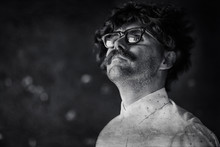 Mustachioed Man In A Classic Suit And Vintage Glasses, Curly Hipster Portrait, Long Hair