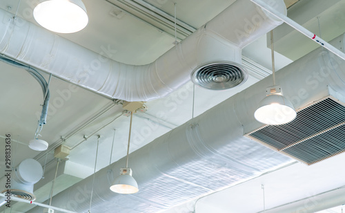 Cuadros en Lienzo Air duct, air conditioner pipe and fire sprinkler system on white ceiling wall