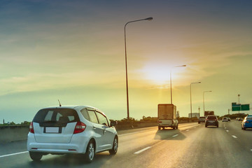 Wall Mural - Car driving on highway road,car on road and sunset background,Transportation