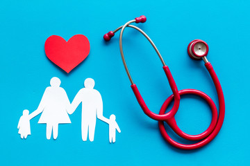  Family health care concept. Heart icon and stethoscope on blue background top view