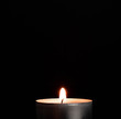 Candle on black background. Candle as a symbol or rite.
