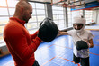 little boy gets pleasure from boxing workout, close up side view photo. pastime, leisure
