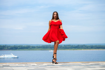 Wall Mural - Beautiful brunette model in sexy red dress