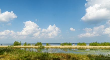 Scenic shot of Lake Superior in Saginaw, Michigan with two strangers entering the beach.