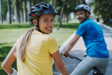 Joyful Woman Enjoying Bicycle Ride With Her Husband
