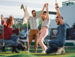 © Zoran Zeremski - Group of smiling friends enjoying together playing mini golf in the city.