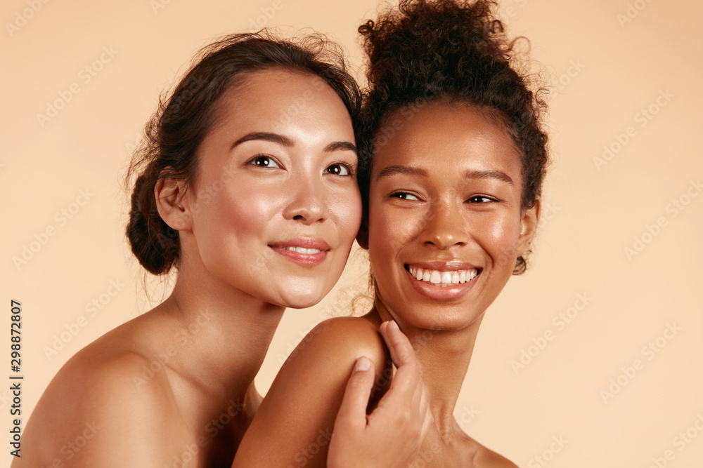 Beauty. Smiling women with perfect face skin and natural makeup portrait. Beautiful happy asian and african girl models with different types of skin on beige background. Spa skin care concept - obrazy, fototapety, plakaty 
