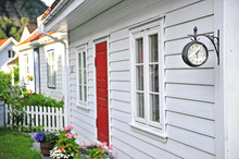 Facade Of Scandinavian House With A Hanging Clock