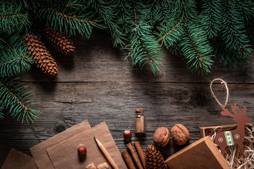 Wall Mural - Christmas green frame from fir branches on a vintage gray board background. Frame of fir branches. Christmas card blank.