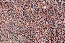 Background Of Small Red Fine Gravel. Walking Path Cover Texture With A Little Dry Twigs