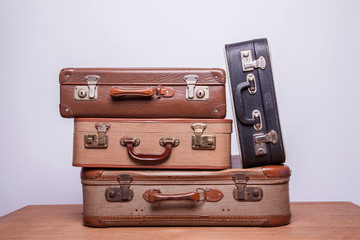 Wall Mural - Old, retro, suitcases lie on the table with white background