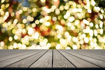 Wall Mural - Mock up perspective empty top wooden board and  Bokeh lights from the Christmas tree is lit from multiple satellites. Suitable for use as a background in media advertising.