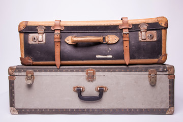 Wall Mural - Old, retro, suitcases lie on the table with white background