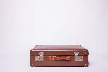 Wall Mural - Old, retro, suitcases lie on the table with white background