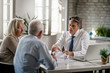 © Drazen - Financial advisor and senior couple talking while going through paperwork on a meeting.